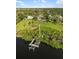 Aerial view showing the home, spacious lot, dock, and waterfront location at 1415 Bayshore Dr, Englewood, FL 34223
