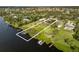 Aerial of home with waterfront access, private dock, and defined property lines at 1415 Bayshore Dr, Englewood, FL 34223