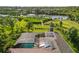 Aerial view of a home with solar panels and a pool overlooking a lush yard and river at 1415 Bayshore Dr, Englewood, FL 34223