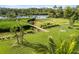 Scenic aerial view of a lush backyard with a boardwalk leading to a waterfront dock at 1415 Bayshore Dr, Englewood, FL 34223