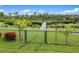 Spacious backyard with lush green grass, fenced area, and access to private wooden bridge at 1415 Bayshore Dr, Englewood, FL 34223