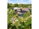 Aerial of backyard featuring screened pool, outdoor seating area, and lush landscaping at 1415 Bayshore Dr, Englewood, FL 34223