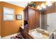 Bathroom showcasing an orange wall, wooden cabinets, and a granite countertop at 1415 Bayshore Dr, Englewood, FL 34223