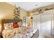 Bright bedroom with a wooden bed frame, fish patterned bedding, closet, and bookshelf at 1415 Bayshore Dr, Englewood, FL 34223
