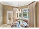 Cozy breakfast nook with views of the backyard pool through shuttered windows and a glass paneled door at 1415 Bayshore Dr, Englewood, FL 34223