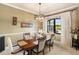 Formal dining room showcases a wood table, upholstered chairs, decorative lighting, and a window with elegant curtains at 1415 Bayshore Dr, Englewood, FL 34223