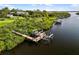 Aerial view of a private dock and boat lift system on a serene waterway at 1415 Bayshore Dr, Englewood, FL 34223