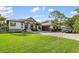Elegant exterior features manicured lawn, attached garage, and a welcoming entrance at 1415 Bayshore Dr, Englewood, FL 34223