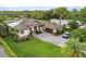 Stunning exterior showcasing landscaped yard, attached garage, and elegant entrance of this gorgeous home at 1415 Bayshore Dr, Englewood, FL 34223