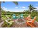 Inviting outdoor fire pit area with Adirondack chairs, perfect for entertaining at 1415 Bayshore Dr, Englewood, FL 34223