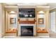 Cozy fireplace with mantel and television, flanked by decorative nooks and sitting areas at 1415 Bayshore Dr, Englewood, FL 34223