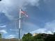 Flagpole with American flag featuring a full rainbow in the beautiful sky at 1415 Bayshore Dr, Englewood, FL 34223