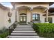 Stately front entrance featuring a grand staircase and double doors at 1415 Bayshore Dr, Englewood, FL 34223