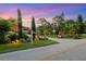 Inviting property with lush landscaping and a picturesque driveway leading to the home at 1415 Bayshore Dr, Englewood, FL 34223