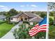 Elegant home exterior showcasing manicured lawn, mature trees, and a charming entrance at 1415 Bayshore Dr, Englewood, FL 34223