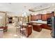 Spacious kitchen with granite countertops, a center island, breakfast bar, and stainless steel appliances at 1415 Bayshore Dr, Englewood, FL 34223