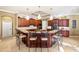 Expansive kitchen area featuring a large island with bar seating, granite counters, and sleek, dark wood cabinetry at 1415 Bayshore Dr, Englewood, FL 34223