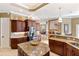 Bright kitchen area boasts granite countertops, stainless steel appliances, a center island and tile flooring at 1415 Bayshore Dr, Englewood, FL 34223