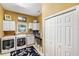 Laundry room features cabinets, modern washer and dryer, and convenient counter space for folding clothes at 1415 Bayshore Dr, Englewood, FL 34223