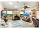 Comfortable living area features a brick accent wall, fireplace, and bar seating at 1415 Bayshore Dr, Englewood, FL 34223