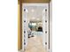 Open doorway reveals a spacious living room with stone accent wall and fireplace at 1415 Bayshore Dr, Englewood, FL 34223