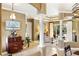 An interior view shows an open floor plan with decorative columns, a large window, and views of the pool area at 1415 Bayshore Dr, Englewood, FL 34223