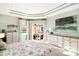 Serene main bedroom with tray ceiling, pool access, and coastal-themed decor at 1415 Bayshore Dr, Englewood, FL 34223