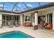 Inviting covered patio features a view of the pool and lounge area at 1415 Bayshore Dr, Englewood, FL 34223