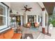 Outdoor patio area with comfortable seating, ceiling fan, and serene views at 1415 Bayshore Dr, Englewood, FL 34223