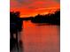 Sunset over the water offering beautiful views at 1415 Bayshore Dr, Englewood, FL 34223
