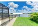 Expansive backyard featuring well manicured lawn and a private dock with access to open water at 15498 Seafoam Cir, Port Charlotte, FL 33981
