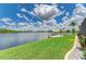 Waterfront home with expansive lawn gently sloping to a tranquil waterway and private boat dock at 15498 Seafoam Cir, Port Charlotte, FL 33981