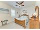 Cozy bedroom with nautical themed decor, including a wooden ship model and beach-themed artwork at 15498 Seafoam Cir, Port Charlotte, FL 33981