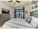 Bedroom featuring water view through sliding glass doors with blue curtains and a ceiling fan at 15498 Seafoam Cir, Port Charlotte, FL 33981