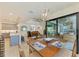 Dining area open to kitchen and living spaces, offering outdoor views and a modern pendant light fixture at 15498 Seafoam Cir, Port Charlotte, FL 33981