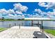 Waterfront home featuring a private dock with boat lift and a brick patio for outdoor entertaining at 15498 Seafoam Cir, Port Charlotte, FL 33981