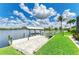 This waterfront property features a private dock with a boat lift and a brick patio overlooking the serene canal at 15498 Seafoam Cir, Port Charlotte, FL 33981