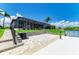 Beautiful exterior view of a waterfront property, showcasing the outdoor patio and dock at 15498 Seafoam Cir, Port Charlotte, FL 33981