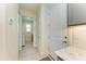 Hallway view showcasing access to the laundry room, bathroom, and additional storage space at 15498 Seafoam Cir, Port Charlotte, FL 33981