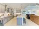 Modern kitchen with granite countertops, stainless steel appliances, and a large central island at 15498 Seafoam Cir, Port Charlotte, FL 33981