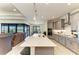Modern kitchen boasting a large island with quartz countertops, gray cabinetry, and stainless steel appliances at 15498 Seafoam Cir, Port Charlotte, FL 33981
