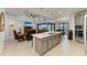 Open-concept kitchen featuring a spacious island, stainless steel appliances, and seamlessly flowing into the living area at 15498 Seafoam Cir, Port Charlotte, FL 33981