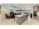 Spacious kitchen with an island, open to living area and dining area with access to the outdoor pool at 15498 Seafoam Cir, Port Charlotte, FL 33981