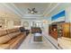 An airy living room with neutral tones, modern furnishings, and an open layout to the kitchen at 15498 Seafoam Cir, Port Charlotte, FL 33981