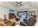 Bright living room with a view of the pool, water, and sliding glass doors to outdoor living area at 15498 Seafoam Cir, Port Charlotte, FL 33981