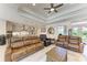 Open-concept living area with modern finishes, tray ceiling, and seamless flow into the kitchen at 15498 Seafoam Cir, Port Charlotte, FL 33981