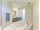 Elegant bathroom featuring a standalone tub, walk-in shower, double vanity, and modern fixtures at 15498 Seafoam Cir, Port Charlotte, FL 33981