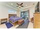 Comfortable main bedroom with access to outdoor pool area, decorative ceiling, and plenty of natural light at 15498 Seafoam Cir, Port Charlotte, FL 33981