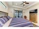 Cozy main bedroom with a sliding door that leads to the pool and a ceiling fan at 15498 Seafoam Cir, Port Charlotte, FL 33981