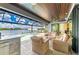 Open-air living space with a pool, spa, grill and bar offering lake views, blending comfort and style at 15498 Seafoam Cir, Port Charlotte, FL 33981